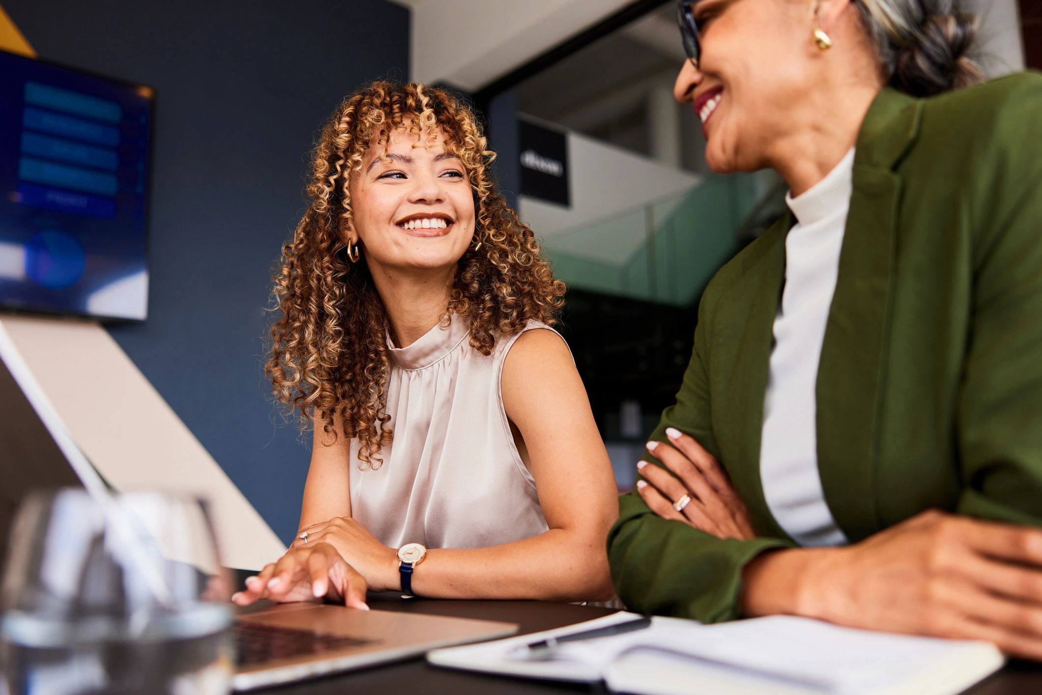 Two women in a supportive conversation, representing coaching