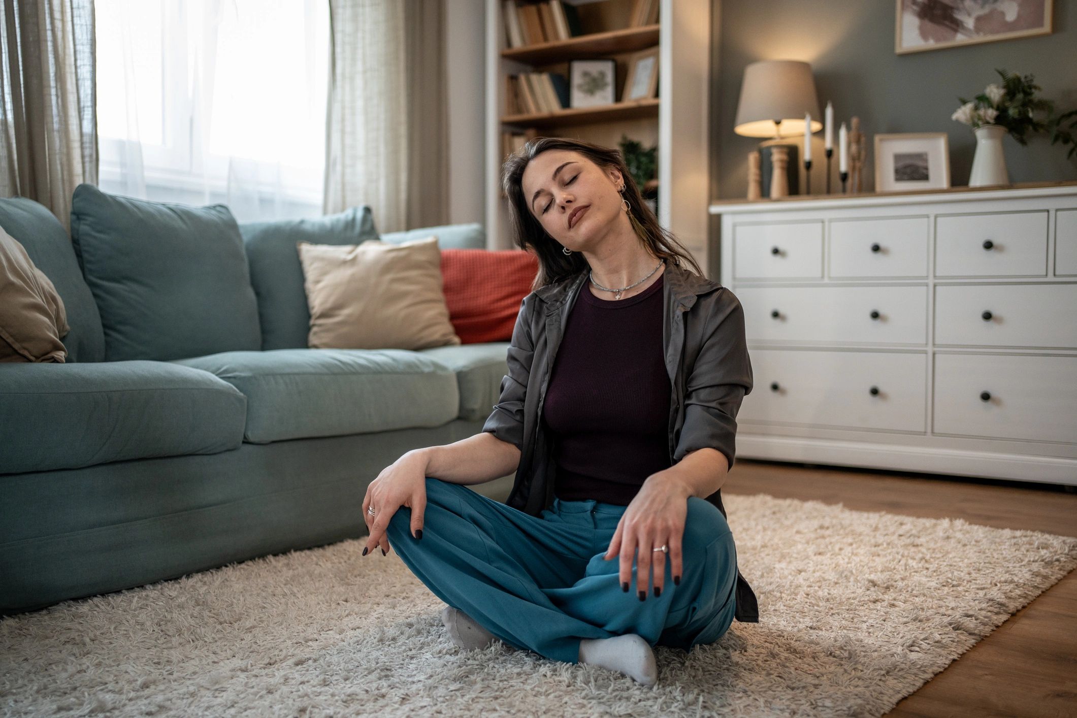 Woman practicing calm breathing at home